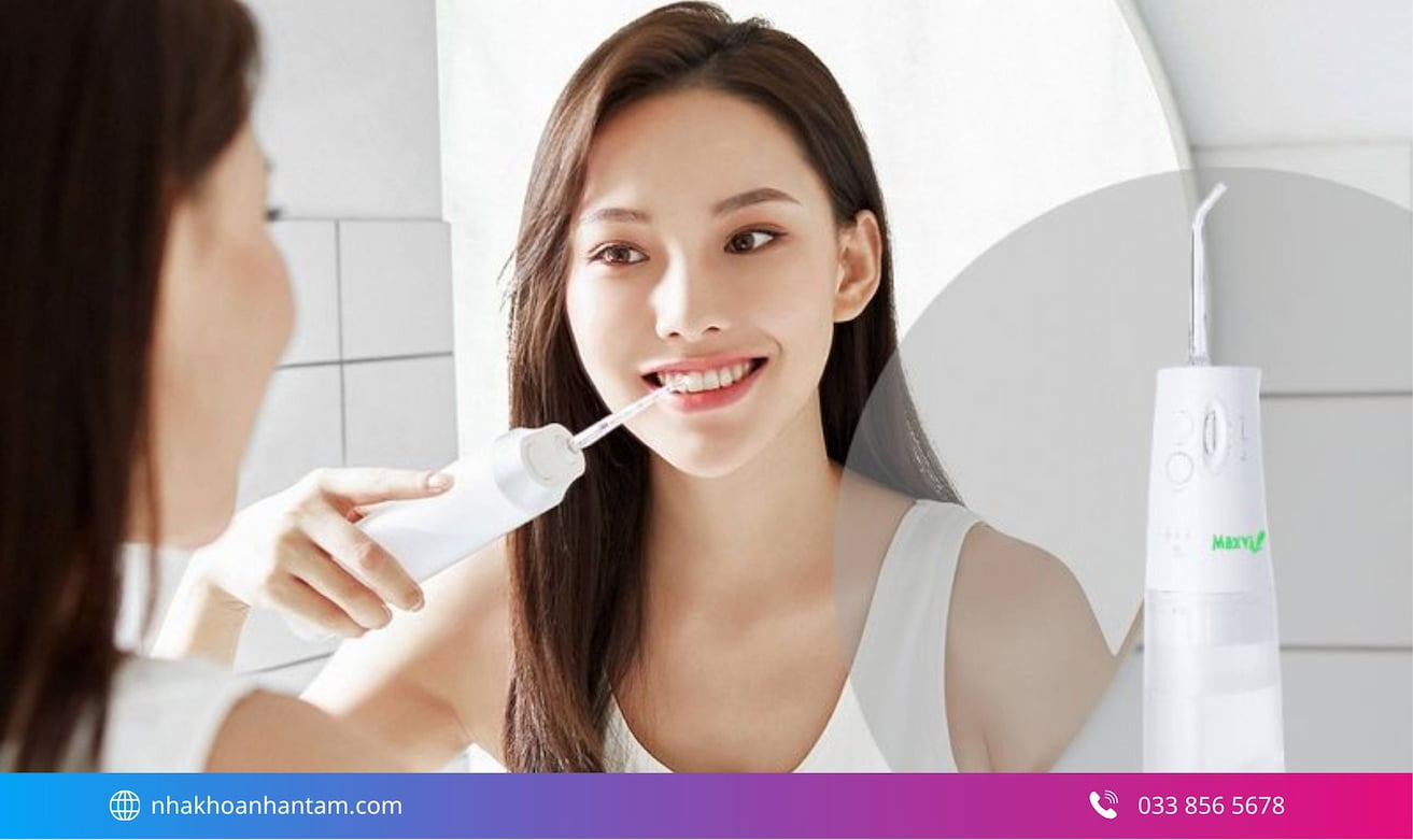 Sử dụng máy tăm nước để làm sạch kẽ răng Hình: Sử dụng máy tăm nước để làm sạch kẽ răng